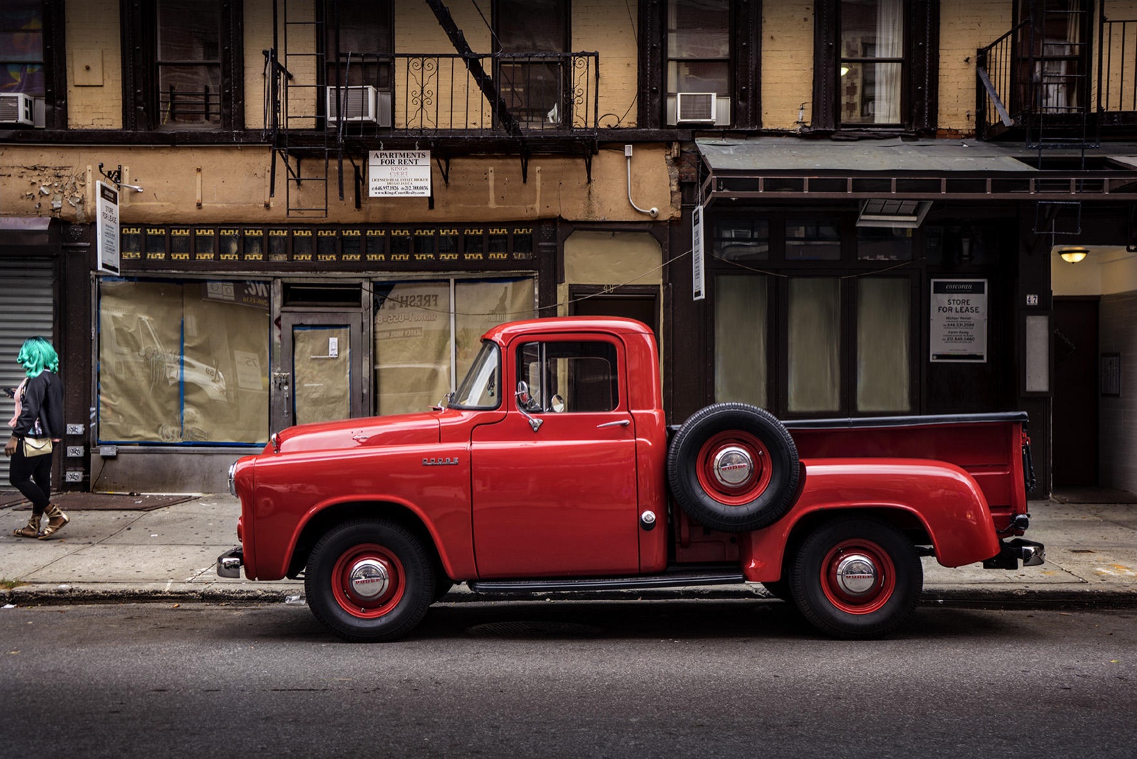 A red vintage Dodge pickup parked on an East Village street, from Sally Davies's Cars series